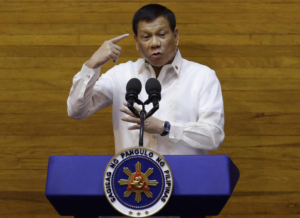 Then-Philippine President Rodrigo Duterte gestures during his second state of the nation address at the House of Representatives in suburban Quezon City, north of Manila, Philippines, on July 24, 2017. Duterte said he would not stop his deadly crackdown on illegal drugs and warned that addicts and dealers have two choices: jail or hell.