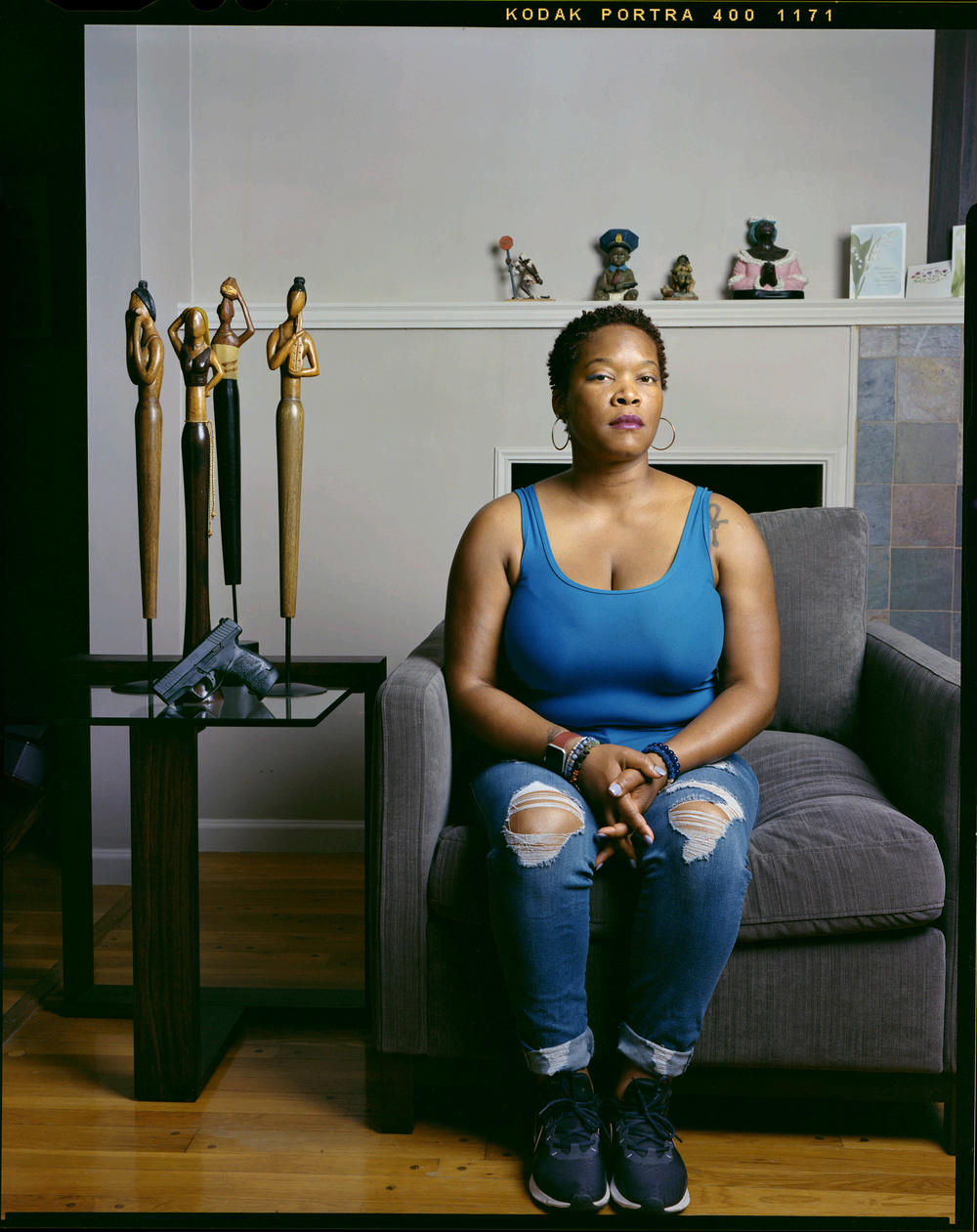 Tiana Tucker, 41, sits inside her mother's home on Tuesday, June 28, 2022, in Chicago. Tucker is a conceal carry firearm instructor. 