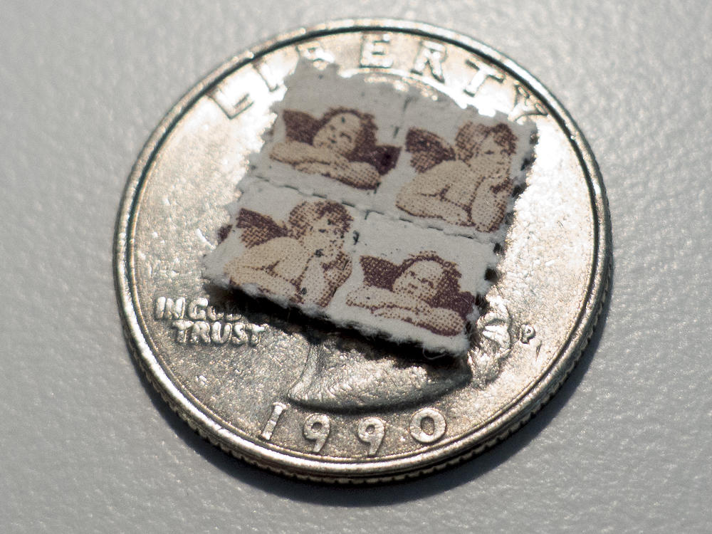LSD blotter tabs sit on top of a US quarter coin. A drug based off of psychedelic LSD appears to relieve depression and anxiety in mice, but without the hallucinogenic side effects.