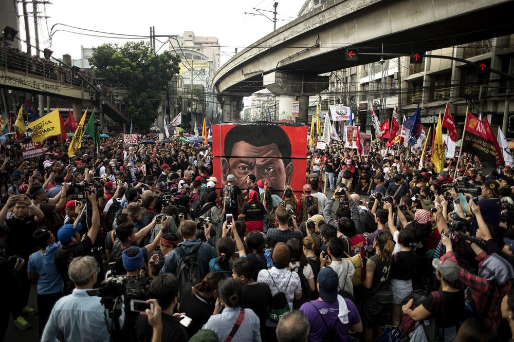 Activists surround an effigy of then-Philippine President Rodrigo Duterte near the Malacañang Palace in Manila on Sept. 21, 2017. Activists held a series of protests on Sept. 21 to denounce drug war killings and what they say is a slide to tyranny under Duterte.