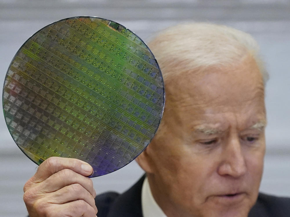 President Biden holds up a silicon wafer in this 2021 file photo.