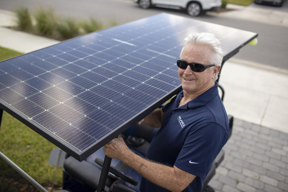 Mark Wilkerson with his solar-powered golf cart. He was one of the first 100 people to move into Babcock Ranch.