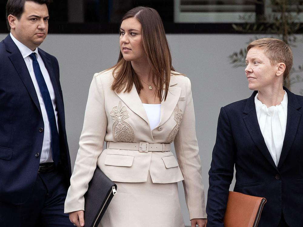 Brittany Higgins, center, leaves the courthouse in Canberra, Australia, on Wednesday.