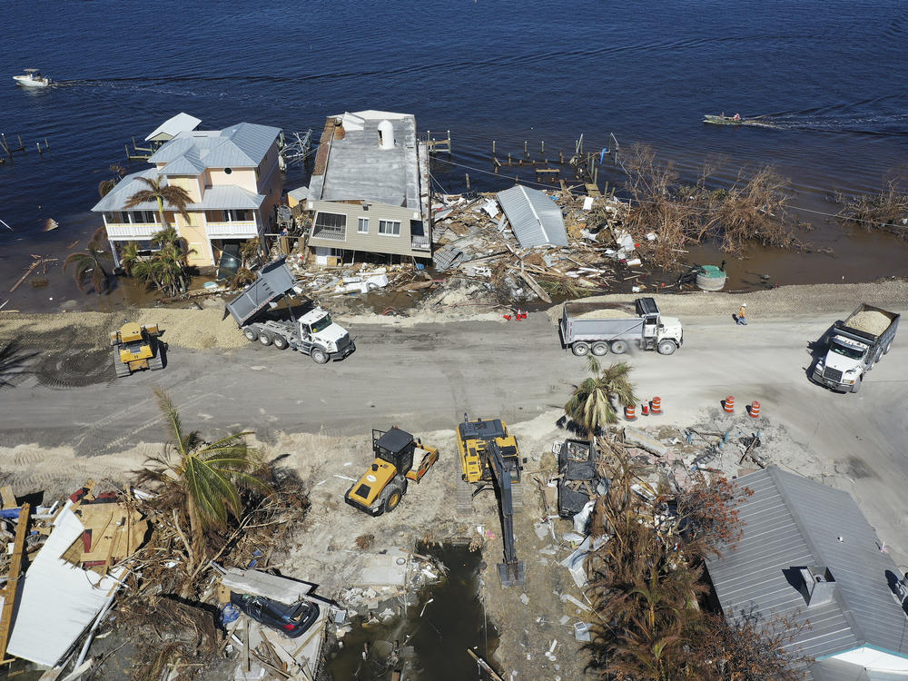Construction crews make repairs to a bridge on the island of Matlacha, in Florida's Lee County, on Wednesday. Lee County's election officials are scrambling to figure out plans for this fall's election.