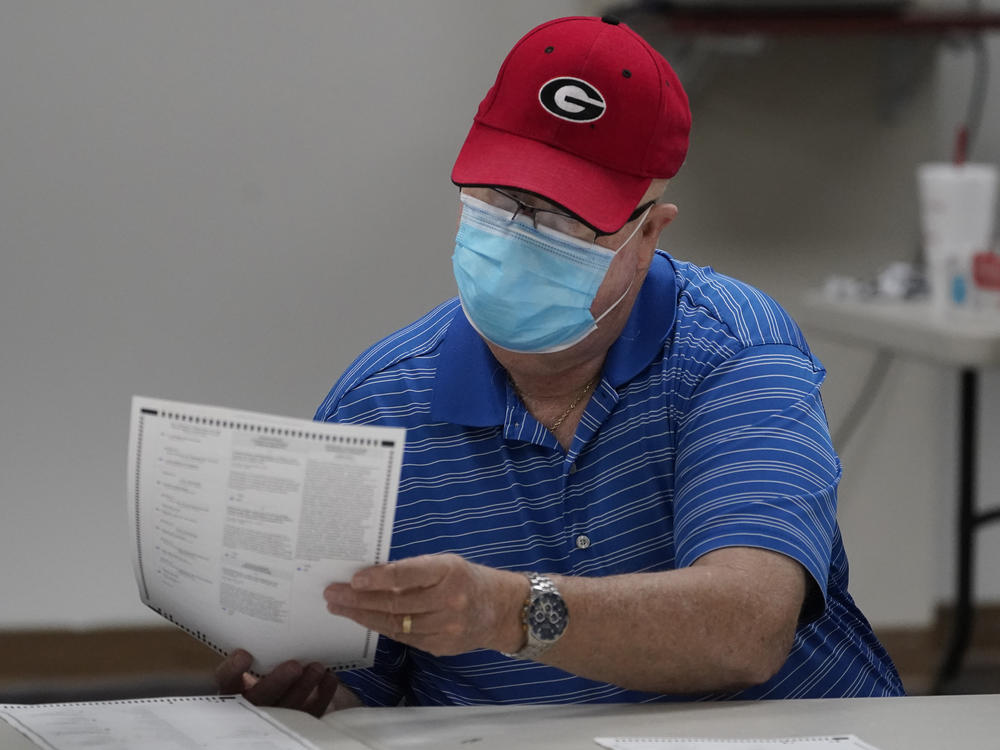 A Georgia election official examines a ballot during that state's hand-count audit in 2020.