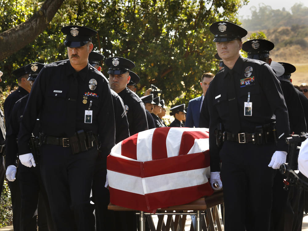 Los Angeles Police Department officers carry the casket of LAPD Officer Houston R. Tipping at the beginning of his memorial service on Wednesday, June 22, in Los Angeles.