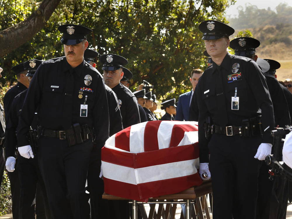 Los Angeles Police Department officers carry the casket of LAPD Officer Houston R. Tipping at the beginning of his memorial service on Wednesday, June 22, in Los Angeles.