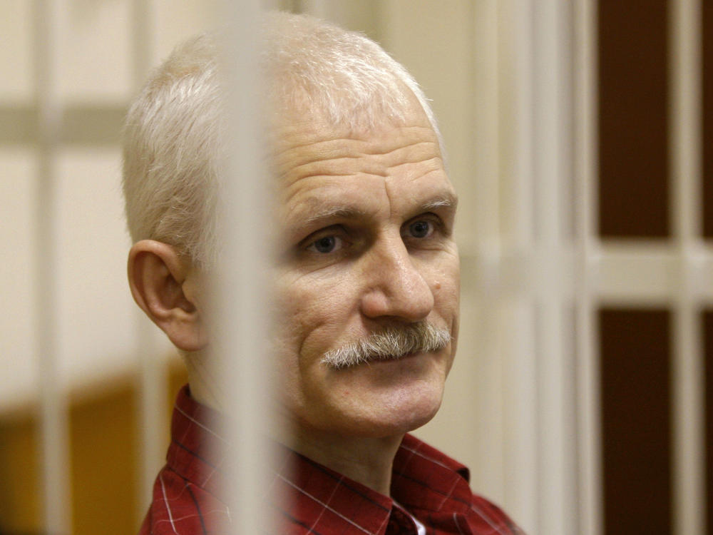 Ales Bialiatski, the head of Belarusian Vyasna rights group, stands in a defendants' cage during a court session in Minsk, Belarus, in 2021.