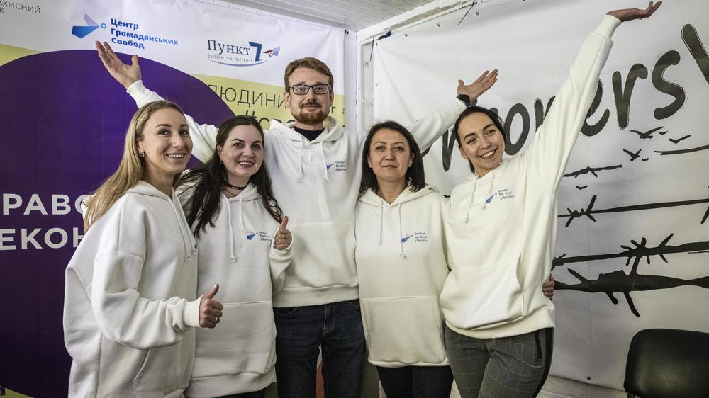 Staff members of the Center for Civil Liberties pose for a photo and celebrate winning the Nobel Peace Prize in their office in Kyiv on Friday.