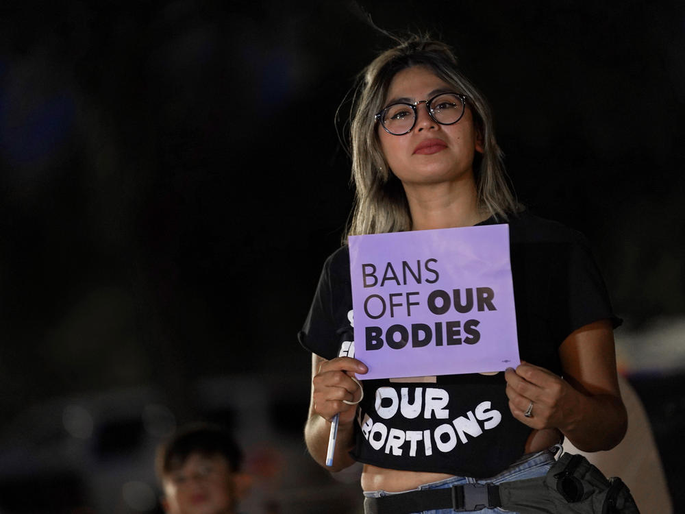 Celina Washburn protests outside the Arizona Capitol to voice her dissent with an abortion ruling on Sept. 23, 2022, in Phoenix.