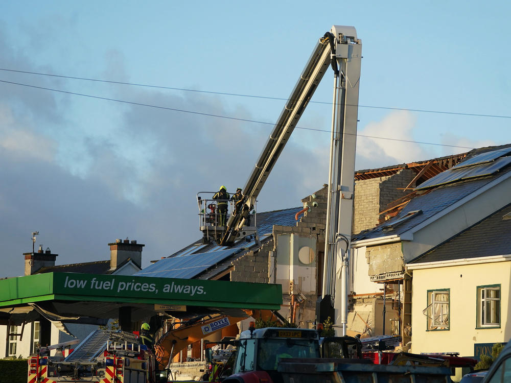 Emergency services work at the scene of an explosion that killed 10 people at a service station in the village of Creeslough in County Donegal, Ireland, on Saturday.