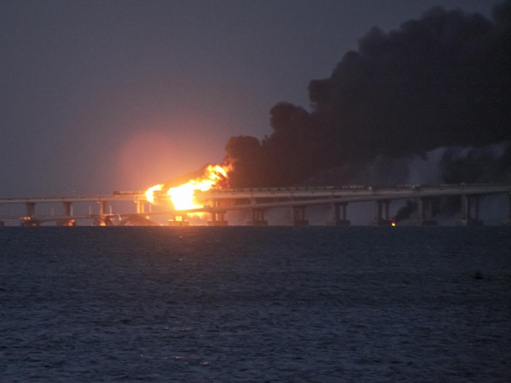 Flame and smoke rise from the bridge connecting the Russian mainland and the Crimean peninsula early Saturday.