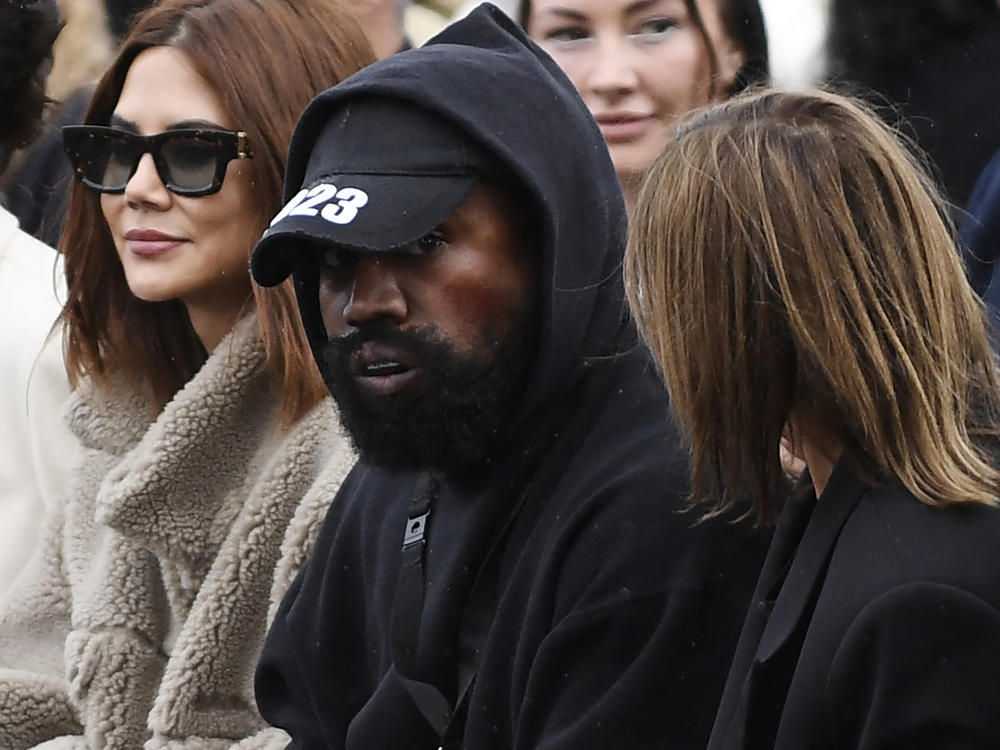 Ye attending Paris Fashion Week, where he ignited controversy wearing a shirt with the slogan 