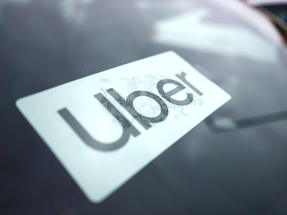 An Uber sign is displayed inside a car in Palatine, Ill., Thursday, Feb. 10, 2022. The U.S. Department of Labor is proposing a new rule on employee classifications, saying workers have incorrectly been deemed independent contractors, which hurts their rights.