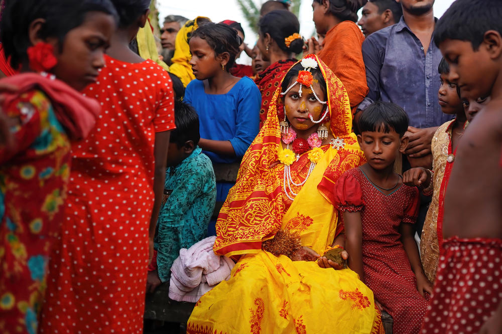 A 14 year old school girl Hafsa sits with friends and neighbors while posing for photos on her wedding day at a village named Joymoni from a coastal area from Mongla in Bagerhat district. Bangladesh witnessed a 13% increase in child marriages during the Covid-19 pandemic last year as the deadly virus massively affected societies and economies, pushing many into extreme poverty.