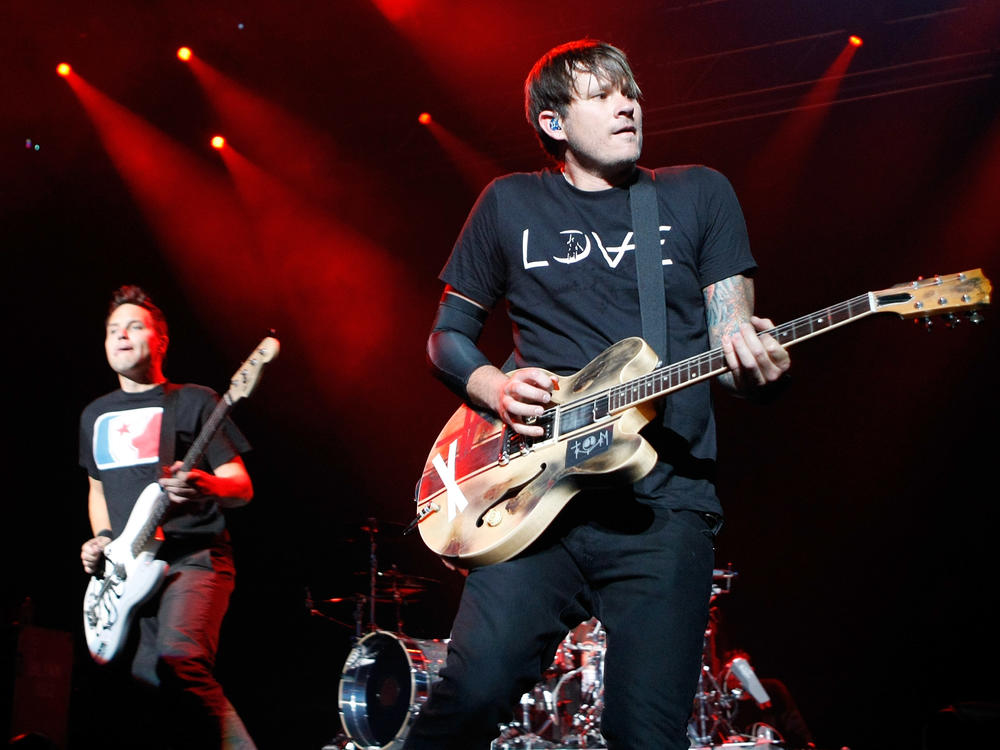 Blink-182 singer/bassist Mark Hoppus (L) and singer/guitarist Tom DeLonge perform in 2009. The band confirmed the classic lineup would once again reunite.