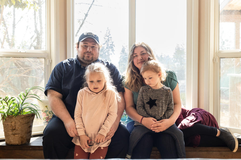 Katie-Jo and Christian Page along with their three children Emalyn, Makenna and Kyla (hiding), at their home in Snohomish, Wash., on Oct. 2.