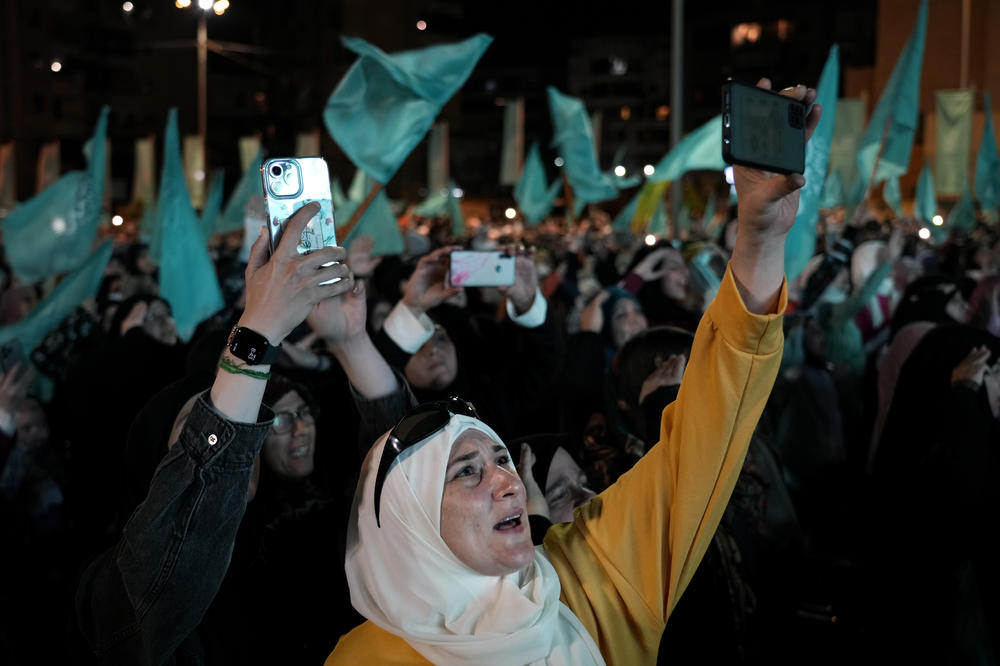 Hezbollah supporters listen to a speech by Hezbollah leader Sayyed Hassan Nasrallah via a video link, during a ceremony marking the Prophet Muhammad's birthday, in the southern Beirut suburb of Dahiyeh on Tuesday. Nasrallah said that the Iran-backed group will not comment on the closing of a maritime border deal between Lebanon and Israel until both parties sign the agreement.
