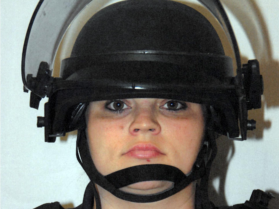 Former Louisville Metro Police officer Katie R. Crews, show in riot gear, pleaded guilty on Tuesday to a federal charge of using excessive force during curfew enforcement the night of David McAtee's death.