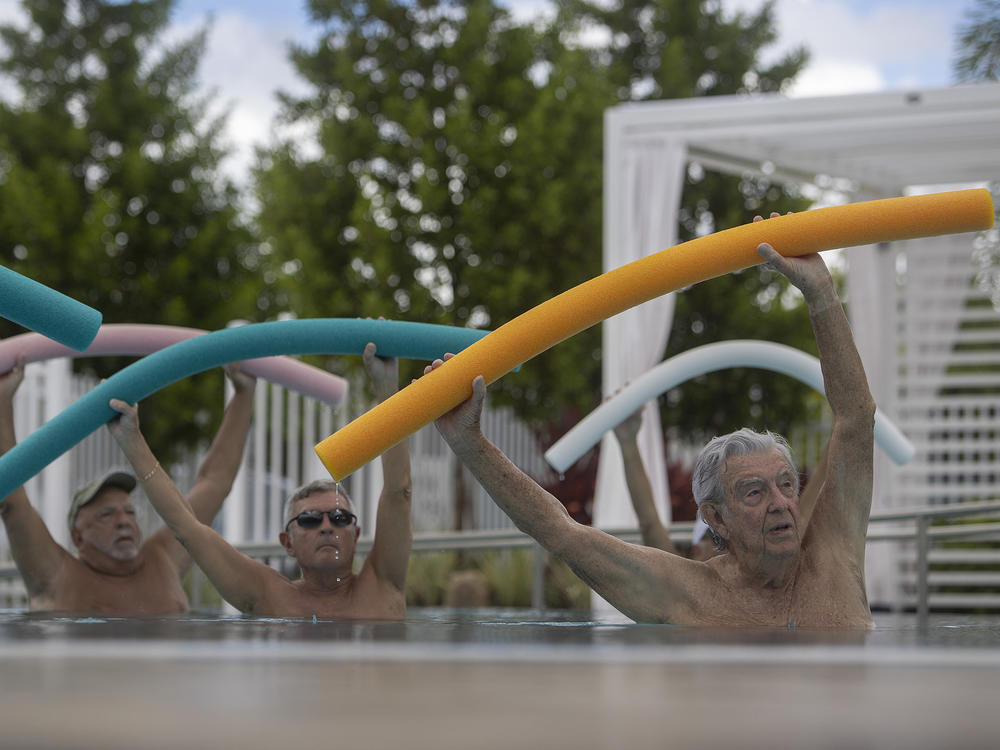 Kevin Soyt, Robert Hamilton and Dave Bayer participate in a water aerobics class in the John Knox Village Continuing Care Retirement Community pool on Oct. 15, 2021 in Pompano Beach, Fla. The Social Security Administration announced the largest cost-of-living adjustment in decades: 8.7%.