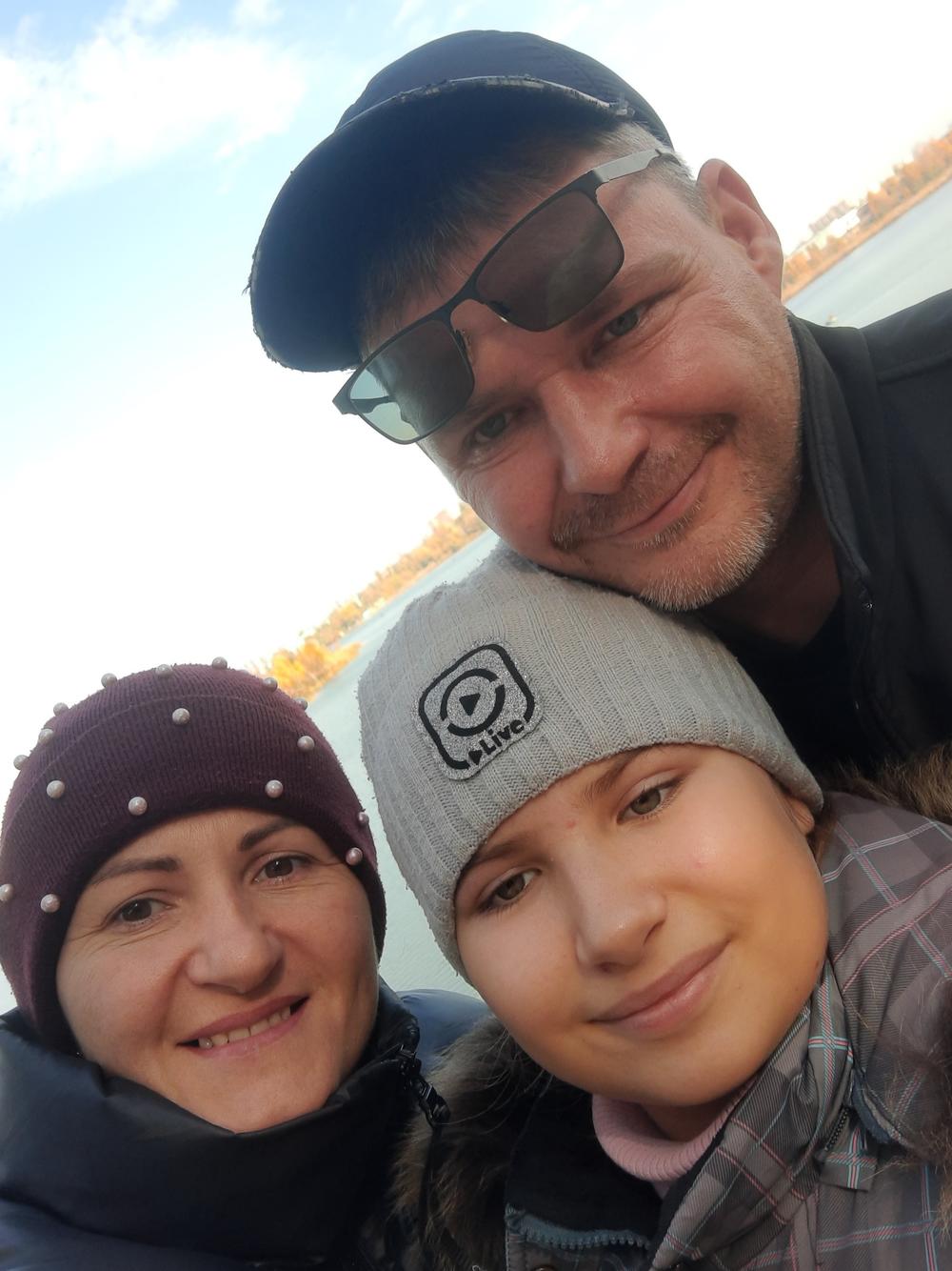 Anastasiya, known as Nasta, with her parents, Iryna and Andriy Grycenko, in October 2021.