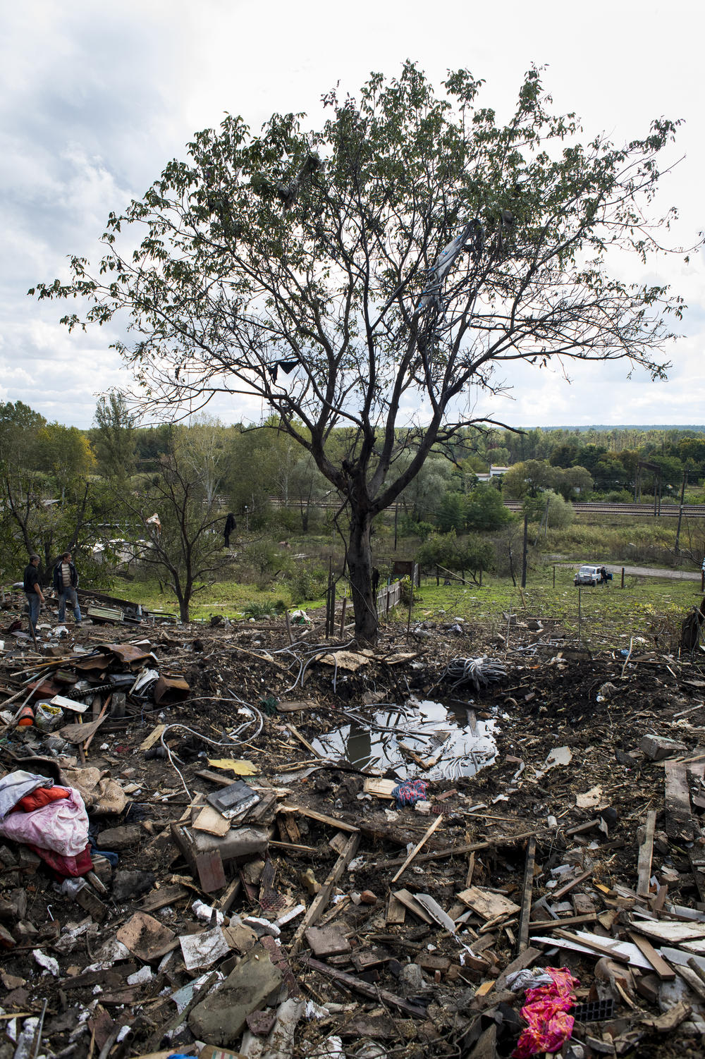 A crater and field of debris are all that remain on Sept. 24 at the site of an explosion that killed 11-year-old Anastasiya Grycenko in Chuhuiv, Ukraine.