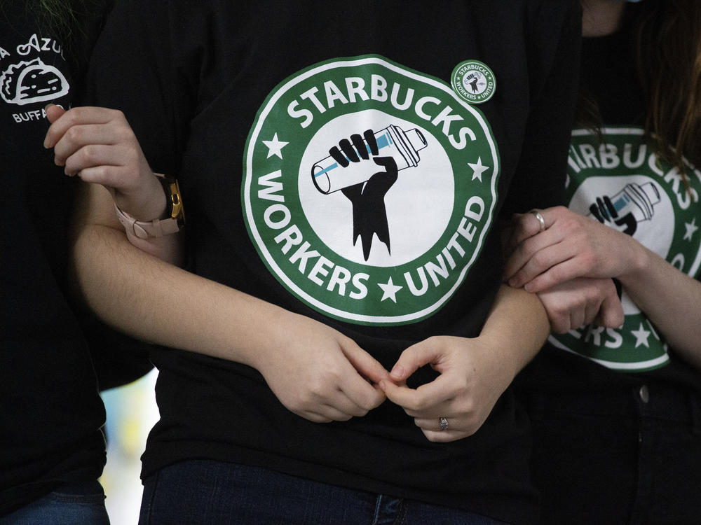 Starbucks employees and supporters react as votes are read during a union-election watch party on Thursday, Dec. 9, 2021, in Buffalo, N.Y. Starbucks workers have voted to unionize over the company's objections, pointing the way to a new labor model for the 50-year old coffee giant.