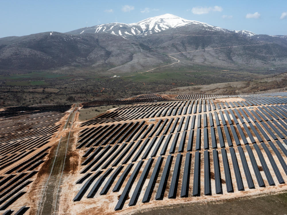 An array of photovoltaic panels are pictured at a solar power park in Kozani, Greece on April 6, 2022. Greece's power transmission operator says it recently hit a new benchmark, using exclusively renewable energy for a brief time.