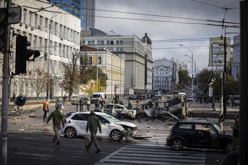 Emergency service personnel attend to the site of a blast on in Kyiv on Monday.
