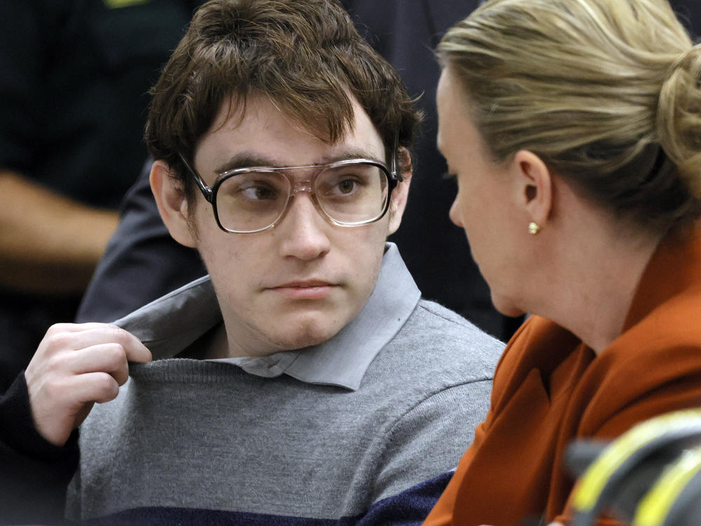 Marjory Stoneman Douglas High School shooter Nikolas Cruz tugs at his shirt collar at the defense table for the verdict in his trial at the Broward County Courthouse on Thursday in Fort Lauderdale, Fla. The jury recommended Cruz receive a life sentence.