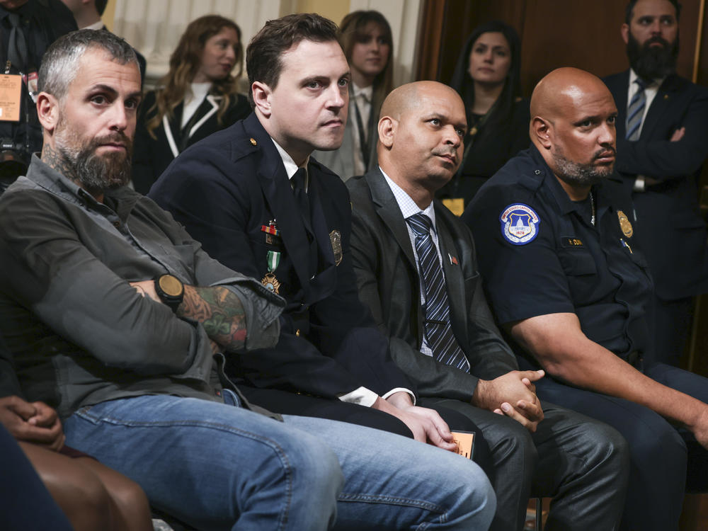 Former D.C. Metro Police officer Michael Fanone, Metropolitan Police Officer Daniel Hodges, Capitol Police Sergeant Aquilino Gonell, and Capitol Police officer Harry Dunn attend Thursday's hearing.