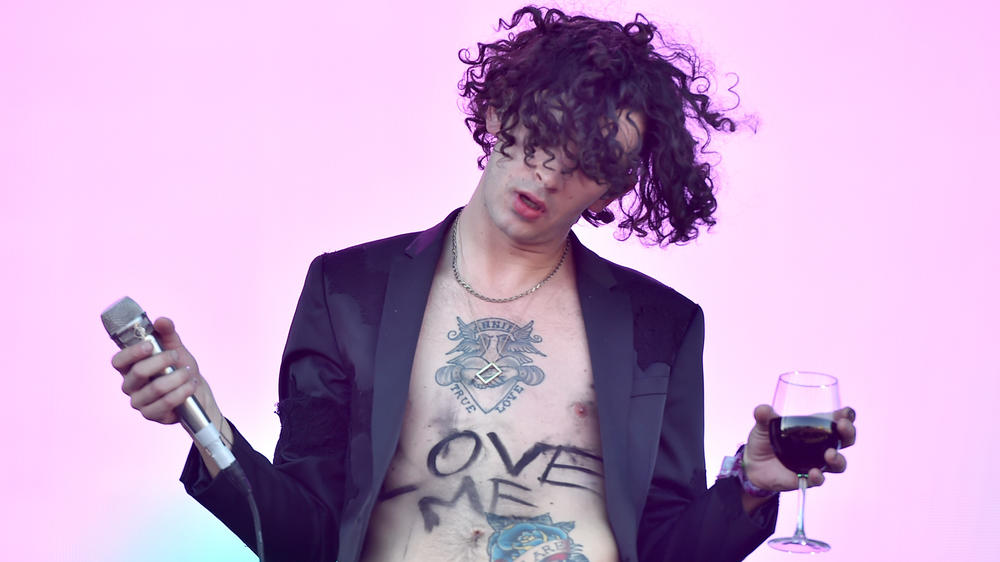 Healy (with the title of one of The 1975's self-aware songs scrawled on his stomach) performs at the Coachella Valley Music and Arts Festival in 2016.