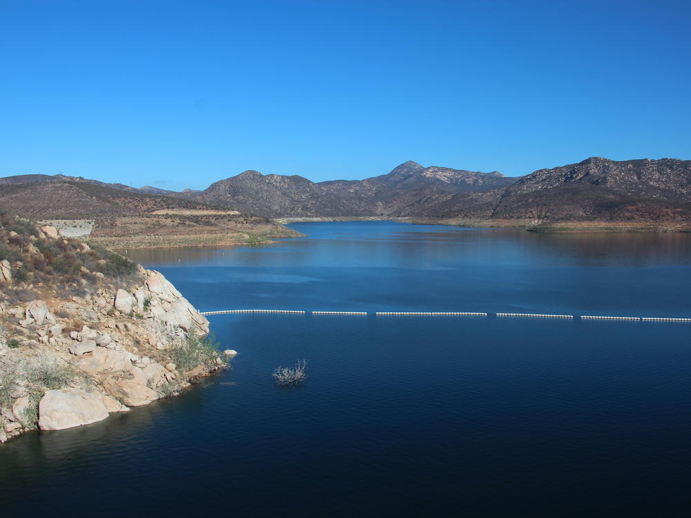 The San Vicente reservoir in San Diego County stores water from as far away as the Colorado River. Pumping water into a smaller reservoir in the surrounding mountains could store excess solar power until it's needed, when the sun sets.