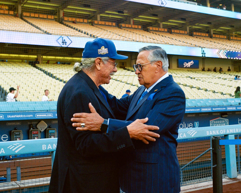 Jarrín greets actor Edward James Olmos at Dodger Stadium earlier this month.