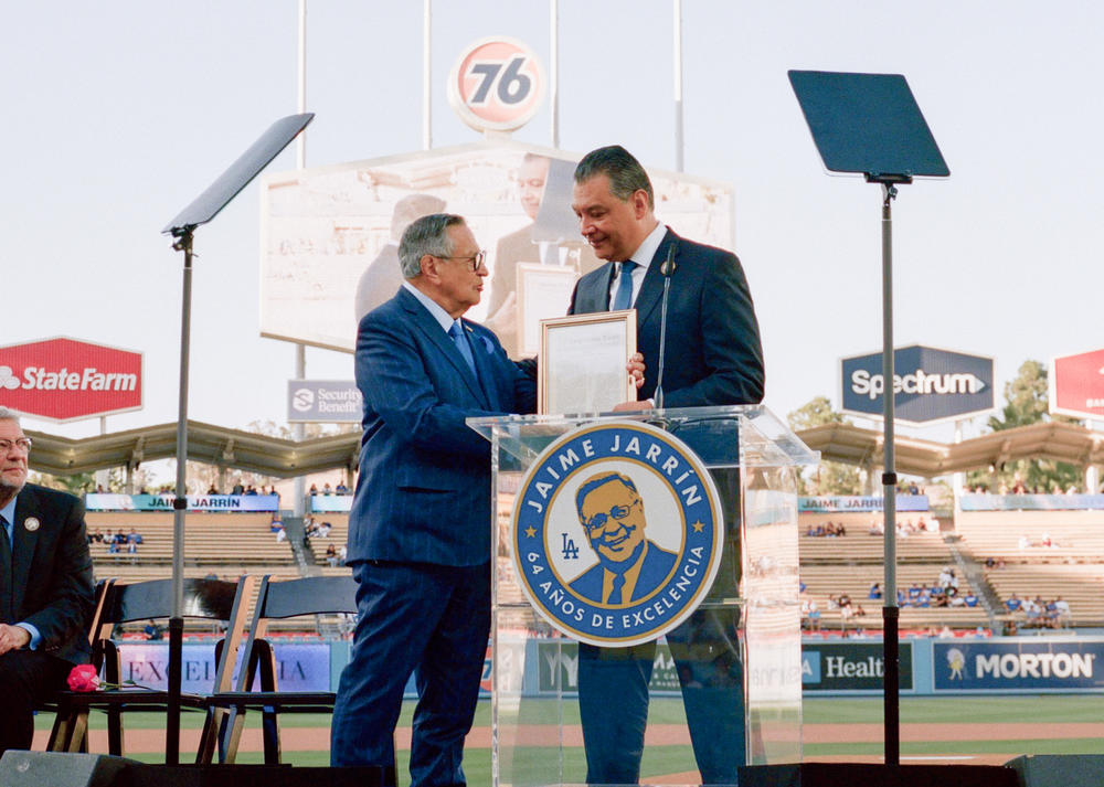 U.S. Senator Alex Padilla presents Jarrín with Congressional recognition on Jaime Jarrín Night at Dodger Stadium earlier this month.