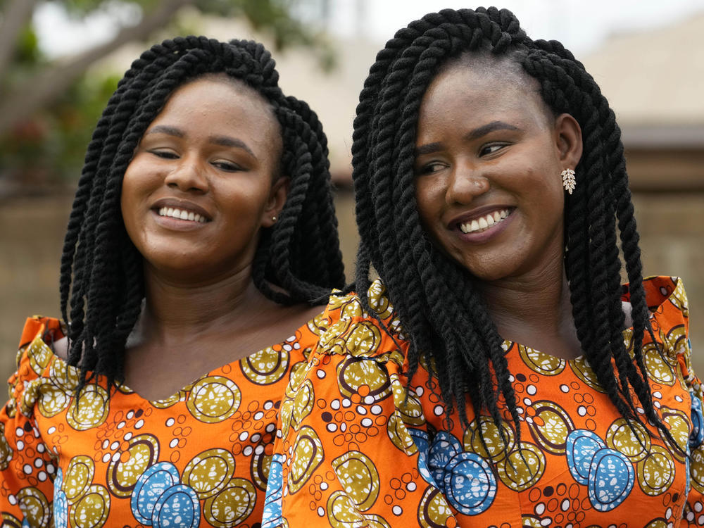 Twins Kehinde Adamolekun, left, and Taiwo Adamolekun, 28, attend the annual twins festival in Igbo-Ora South west Nigeria, Saturday, Oct. 8, 2022.