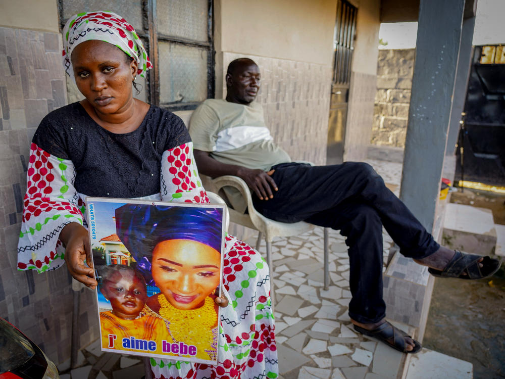 Mariama Kuyateh, 30, holds up a picture of her son Musa, whose death from acute kidney failure on Oct. 10 was linked to contaminated cough syrup imported to Gambia, where they live, from India. The World Health Organization issued an alert about the medication.