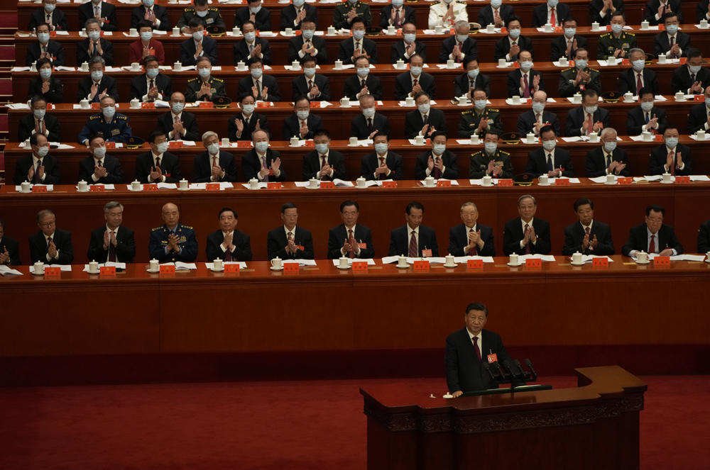 Delegates applaud as Chinese President Xi Jinping speaks.
