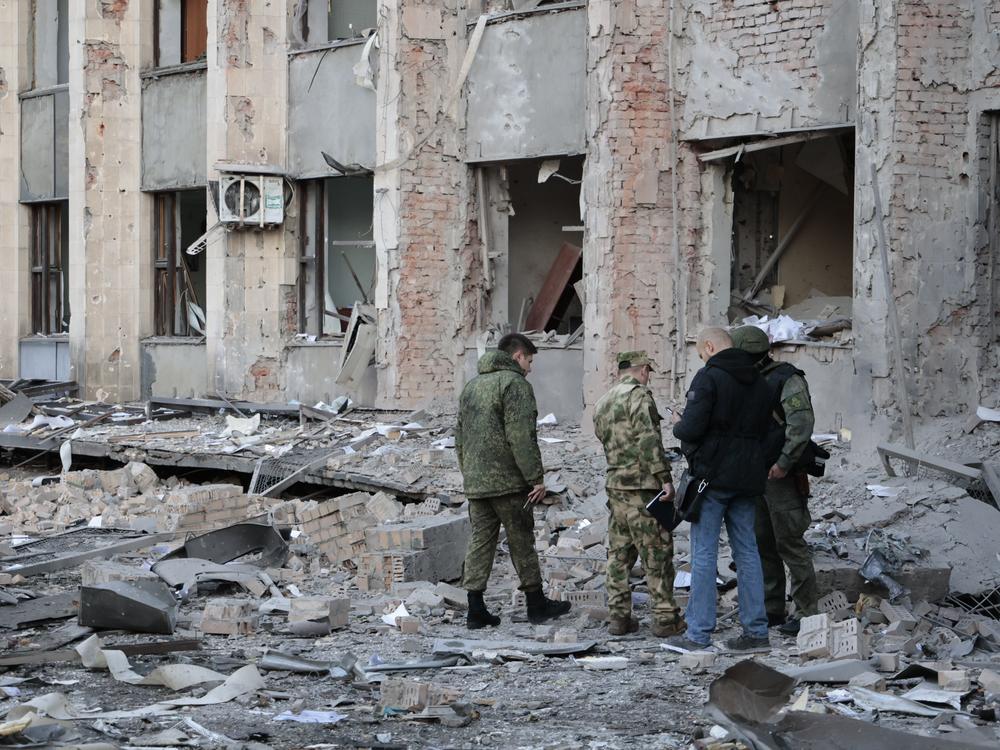 Investigators inspect a site after shelling near an administrative building in Donetsk, the capital of the separatist Donetsk People's Republic in eastern Ukraine, on Sunday.
