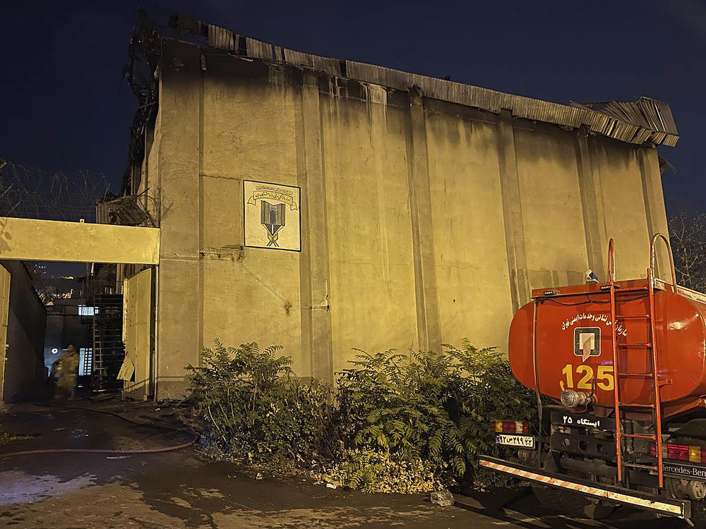 In this photo provided by Islamic Republic News Agency, IRNA, on Sunday, Oct. 16, 2022, a charred building is seen after a fire on the property of the Evin prison, in Tehran, Iran.