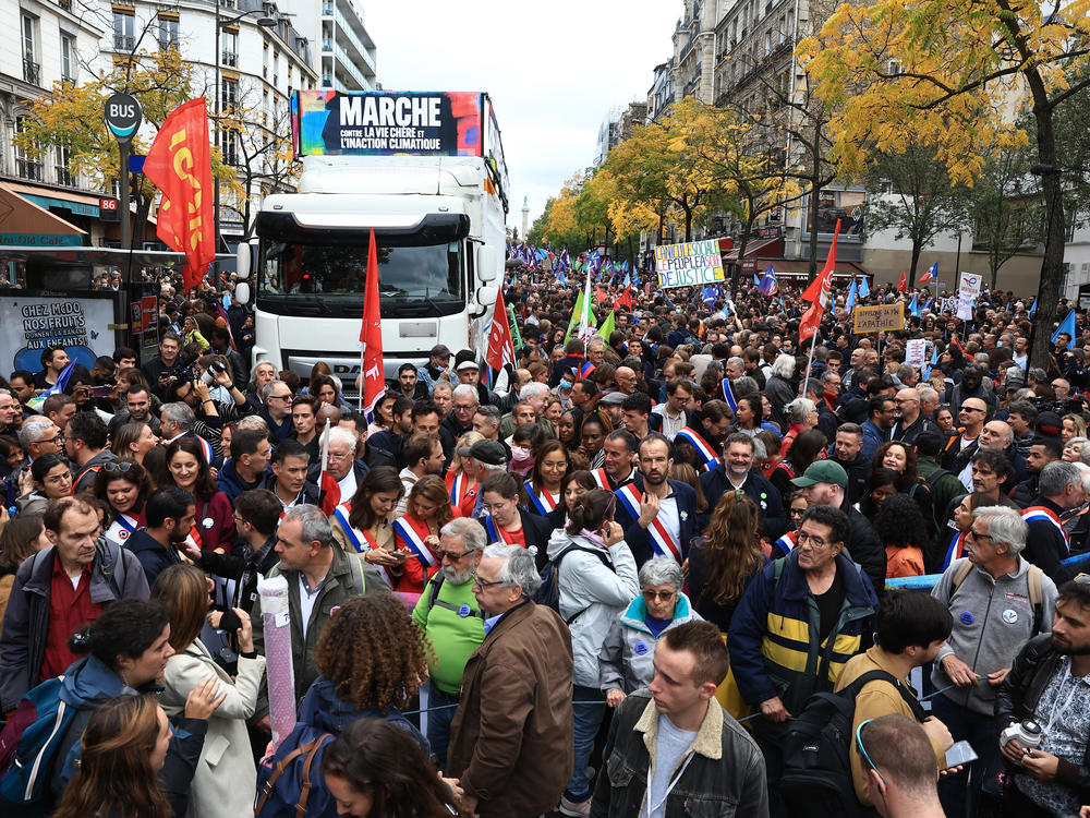 People gather for a protest march against the high cost of living and climate inaction in Paris on Sunday.