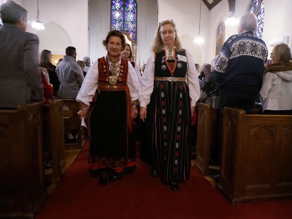 Jeannette Henrikssen, president of the church council, right, and Queen Sonja of Norway walk out of Den Norske Lutherske Mindekirke, the Norwegian Lutheran Memorial Church in Minneapolis, on Sunday.