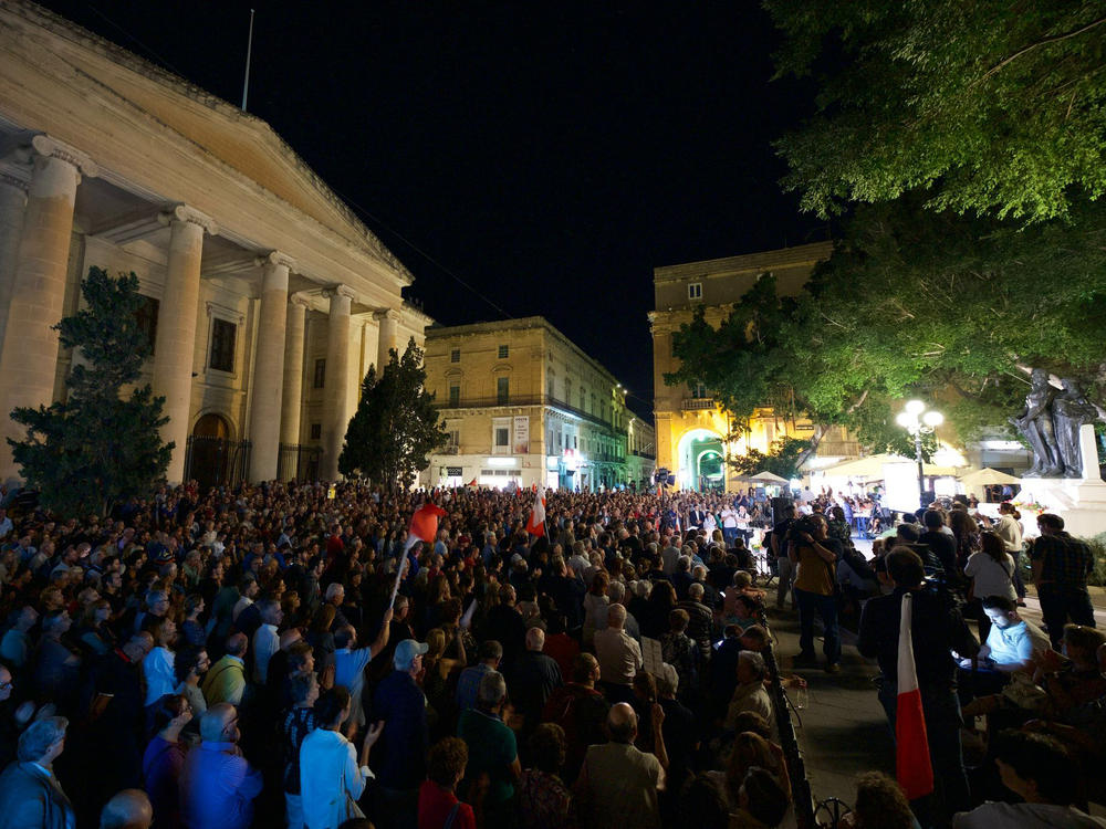 People attend a gathering to remember Daphne Caruana Galizia, at La Valletta, in Malta. Malta is marking the fifth anniversary of the car bomb slaying of the investigative journalist.