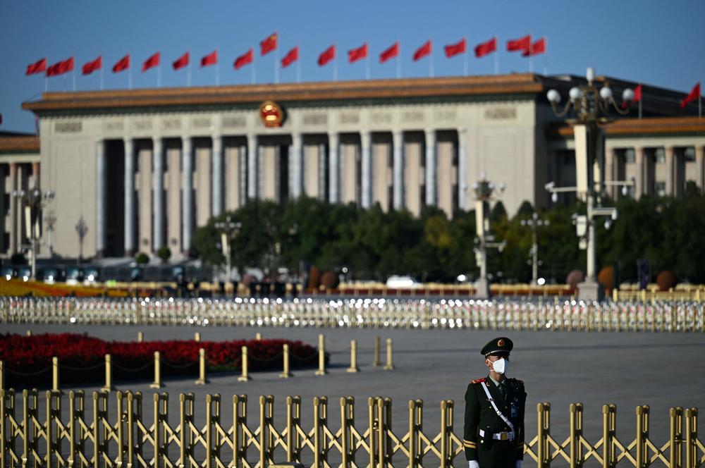 A member of the security staff keeps watch in front of the Great Hall of the People in Beijing.