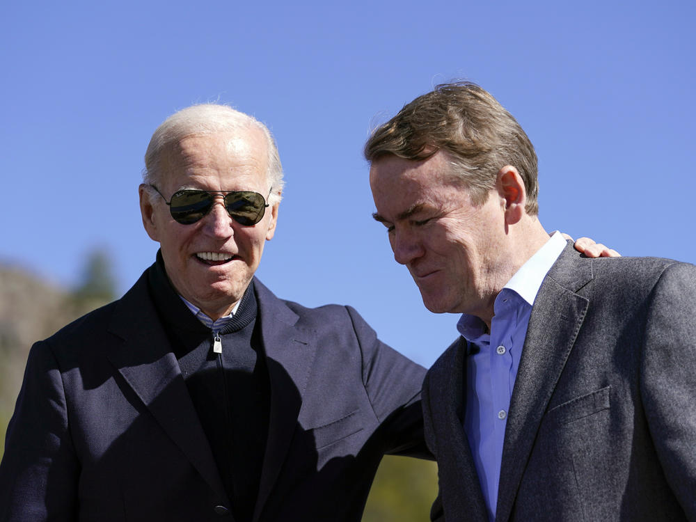 As he announced a new conservation project in Colorado, President Biden made sure Sen. Michael Bennet — who's in a competitive reelection race — was in the shot.