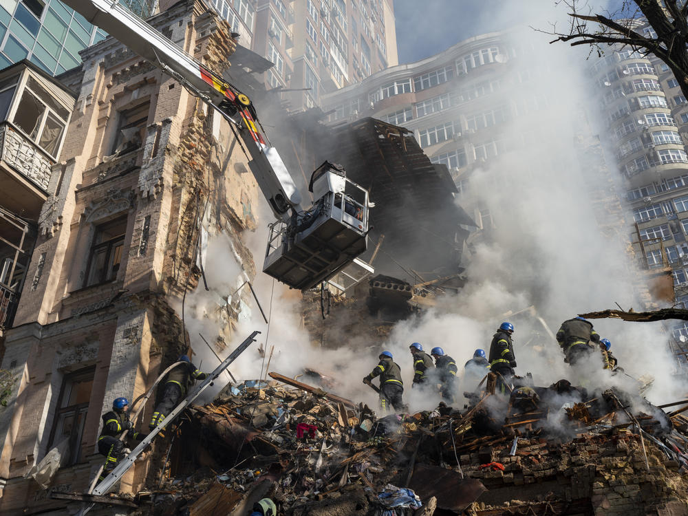 Firefighters work after a drone attack on buildings in Kyiv, Ukraine, Monday. It was the second Monday in a row of Russian strikes on the Ukrainian capital.