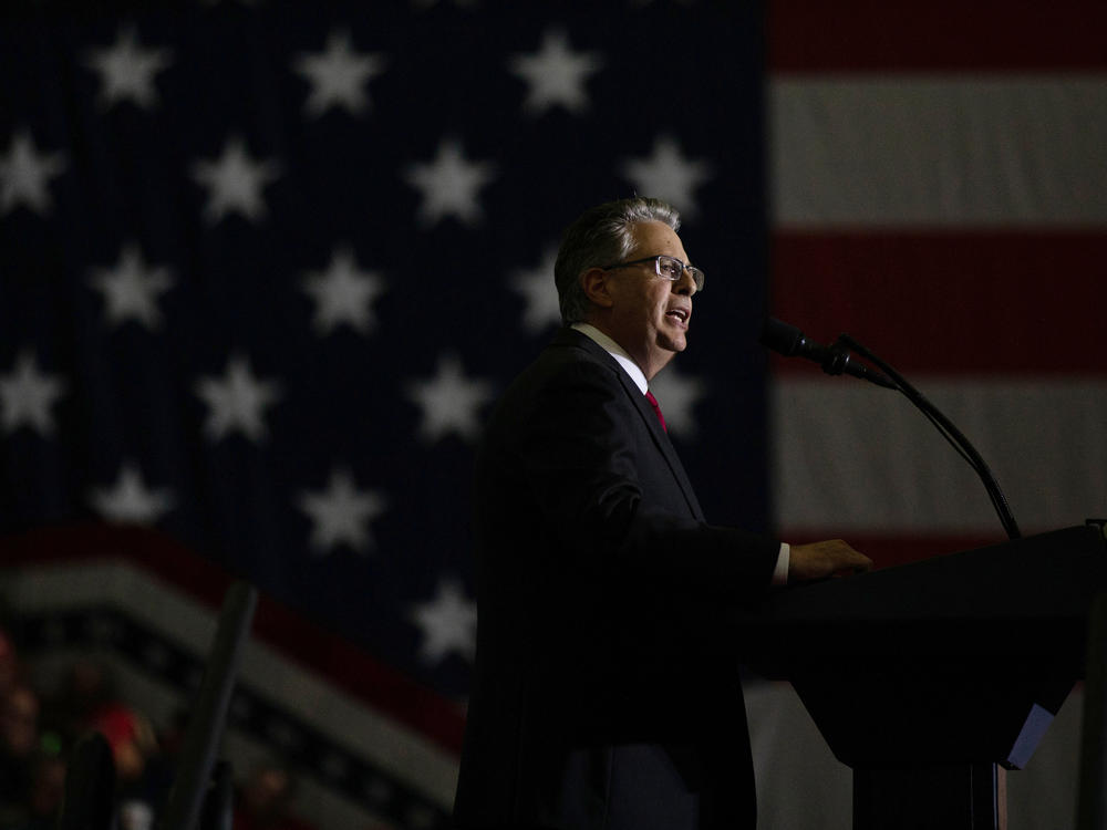 Matthew DePerno, the Republican nominee for Michigan attorney general, speaks during a Trump rally on Oct. 1 in Warren, Mich. DePerno is being investigated for his involvement in an alleged scheme to tamper with voting machines.