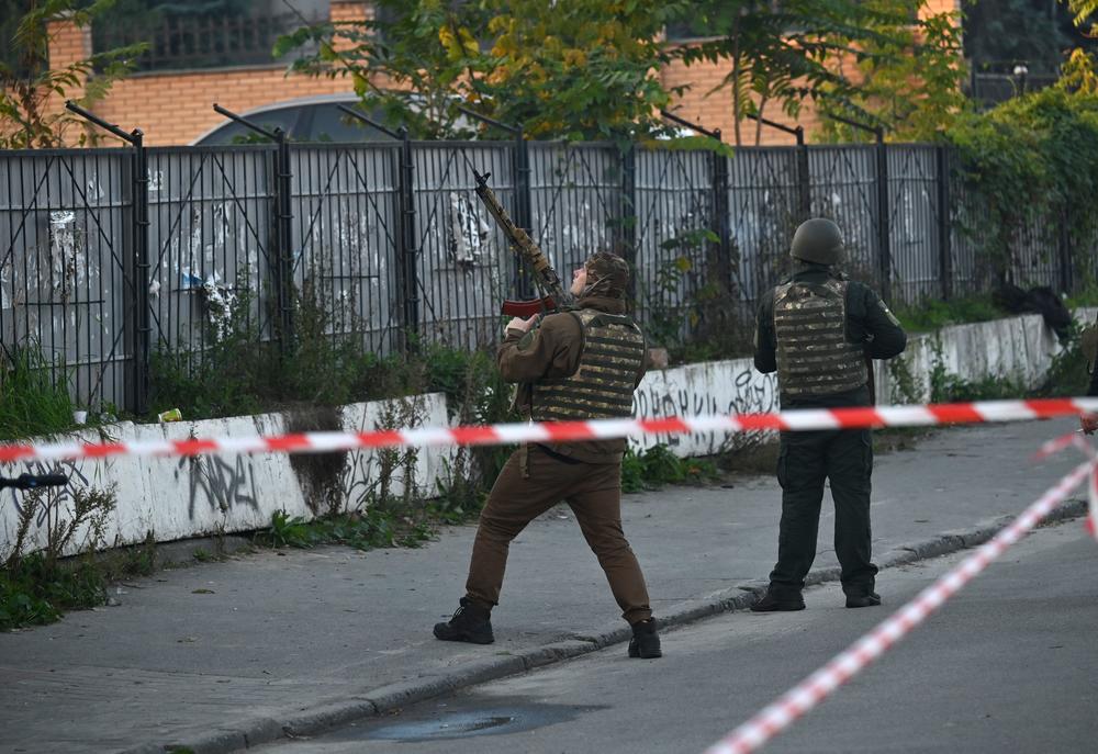A Ukrainian serviceman attempts to shoot down a drone in Kyiv on Monday.