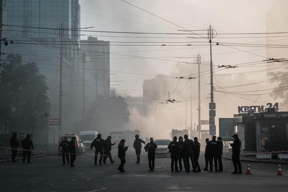 Ukrainian police officers secure the area after a drone attack in Kyiv on Monday.