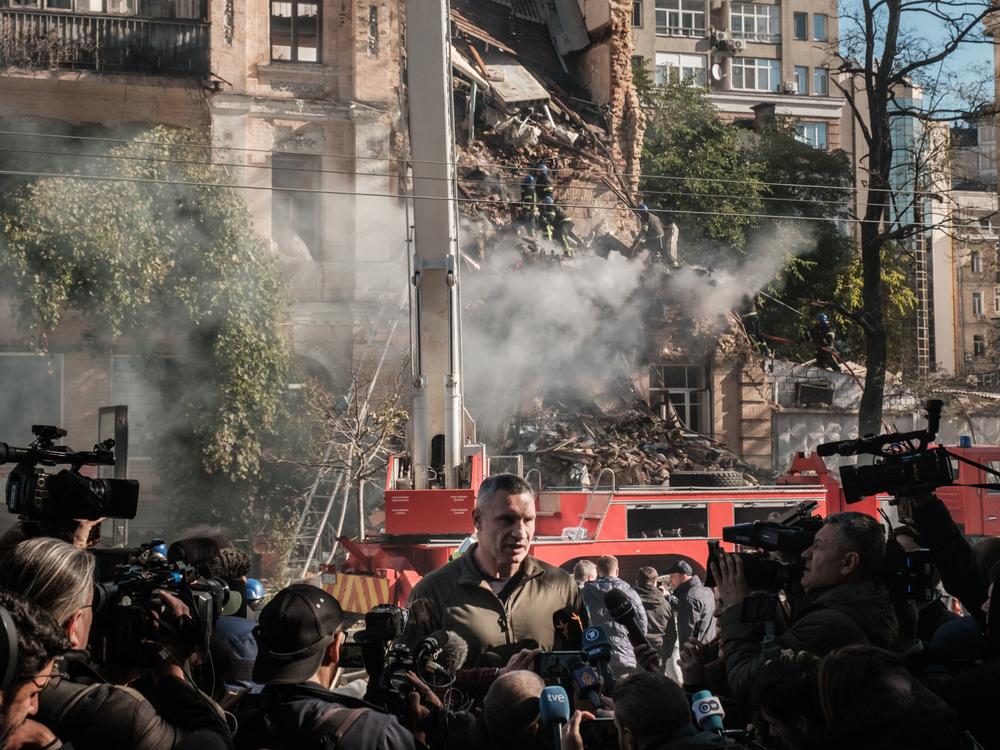 Kyiv Mayor Vitali Klitschko speaks to reporters in front of a building destroyed by a Russian drone strike Monday.